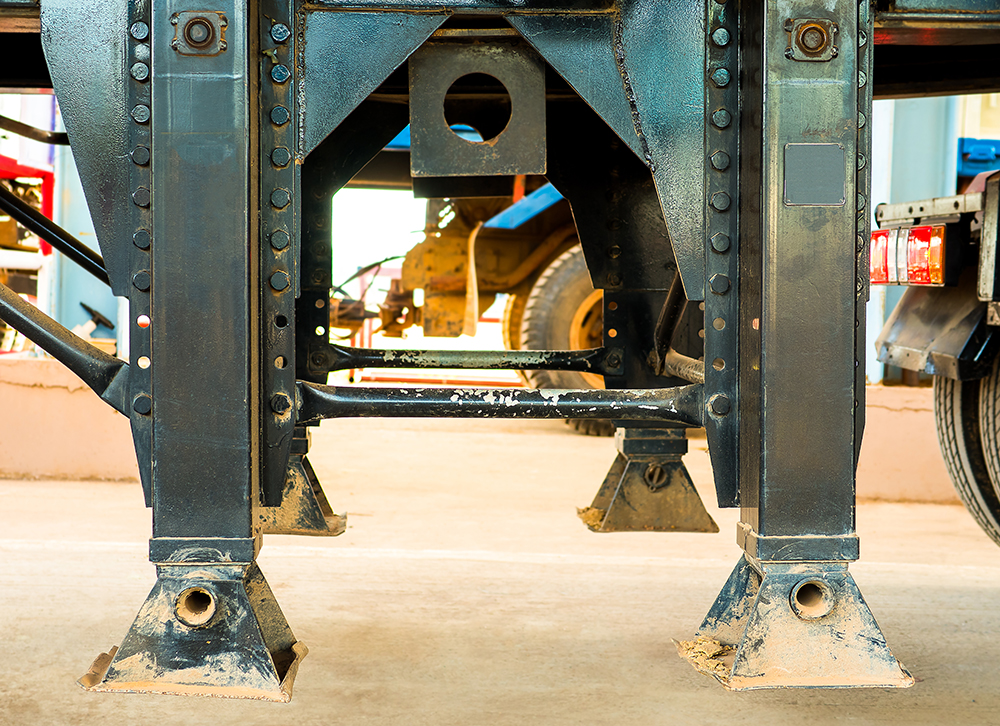 Landing gear on truck. Close up of Landing gear carbon steel on trailer truck or landing legs.  - Truck and trailer parts concepts. 