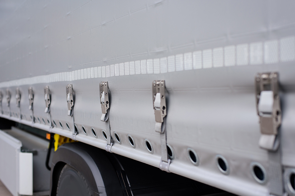 View of the tarpaulin covering the semi-trailer of the truck. Truck transport.